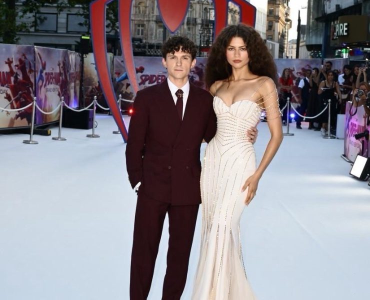 Check out Tom Holland's scene-stealing burgundy suit and Spider Brooch!
