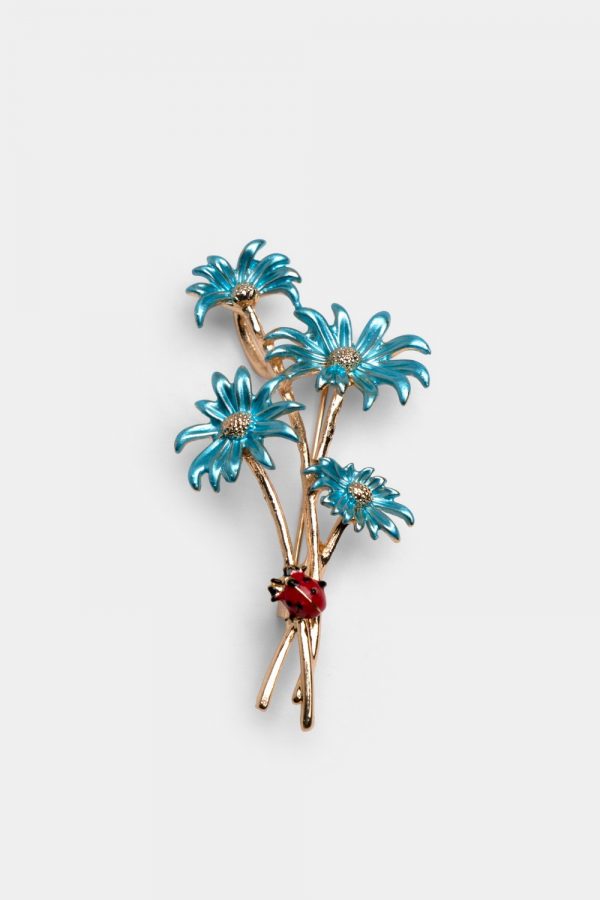 light blue gerbera flower with ladybug brooch dgrie